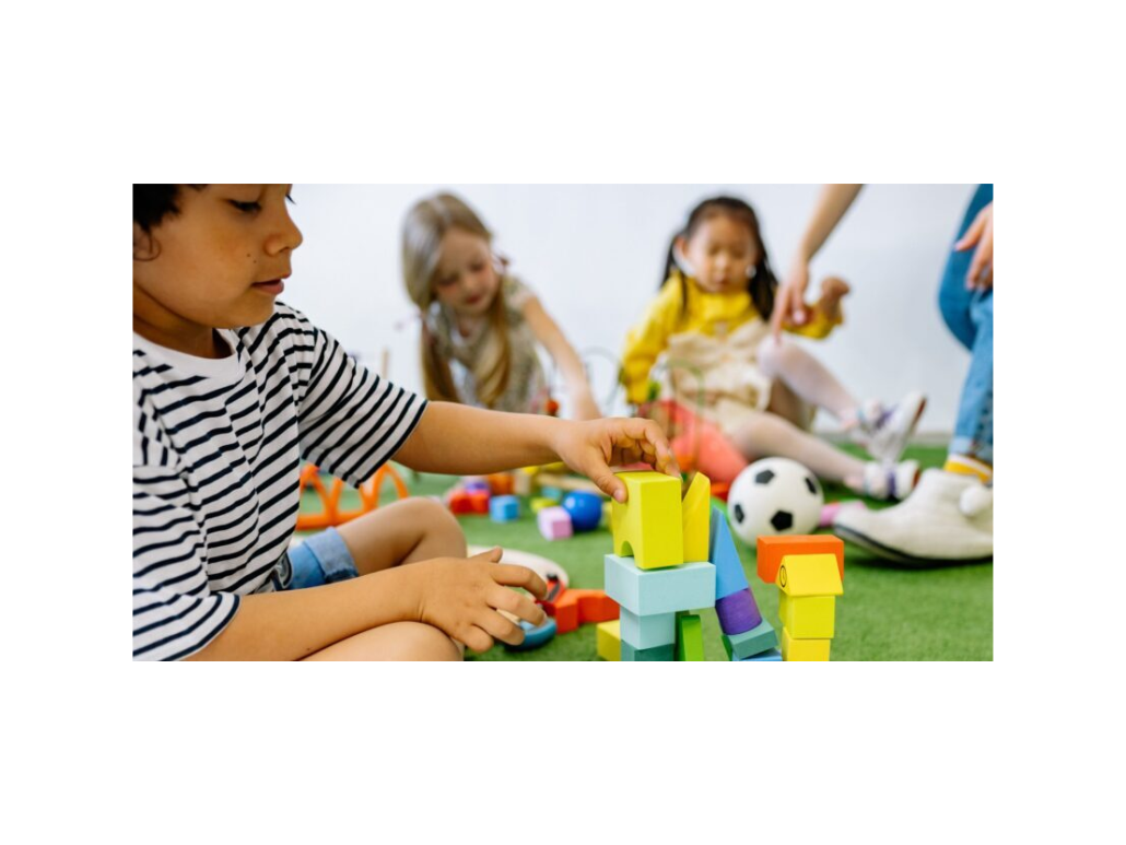 Children playing with blocks and toys indoors.