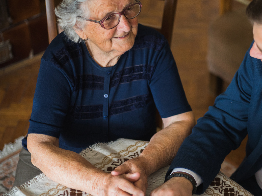 An older person and an attorney sitting together at a table