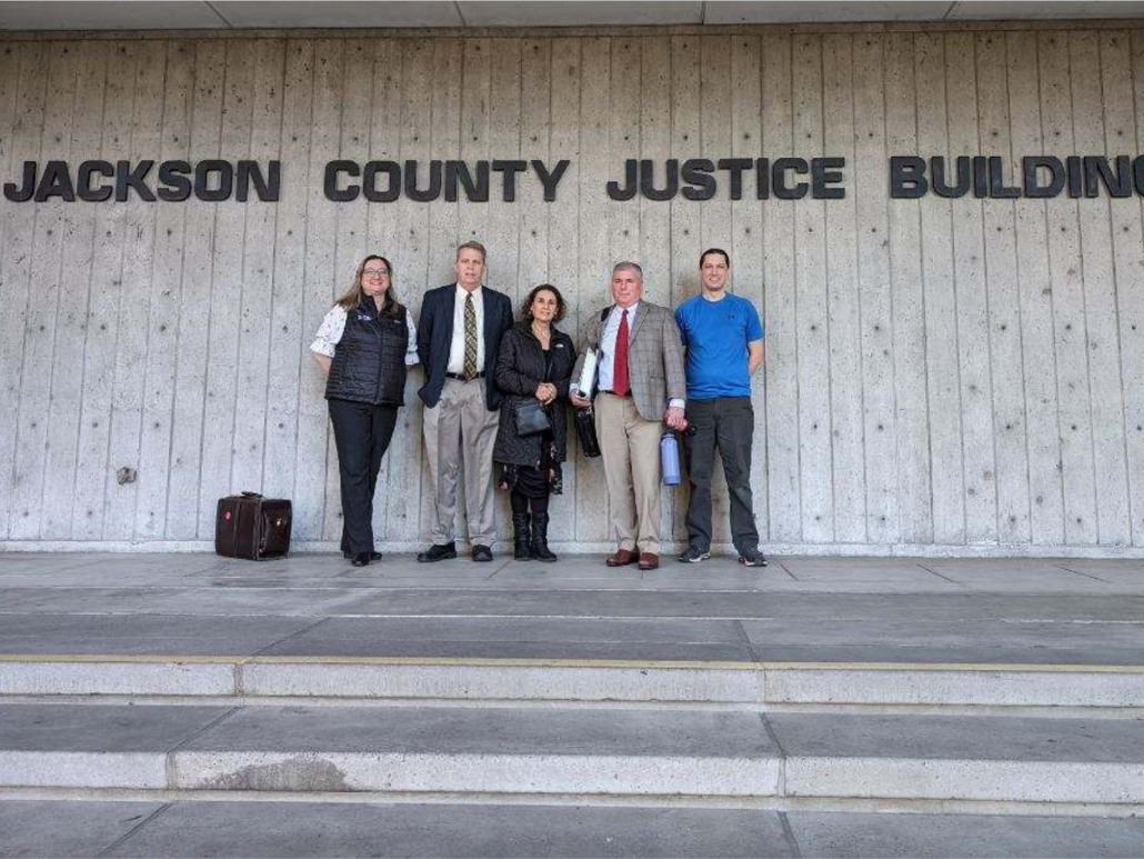  Group of people standing in front of Jackson County Justice Building.