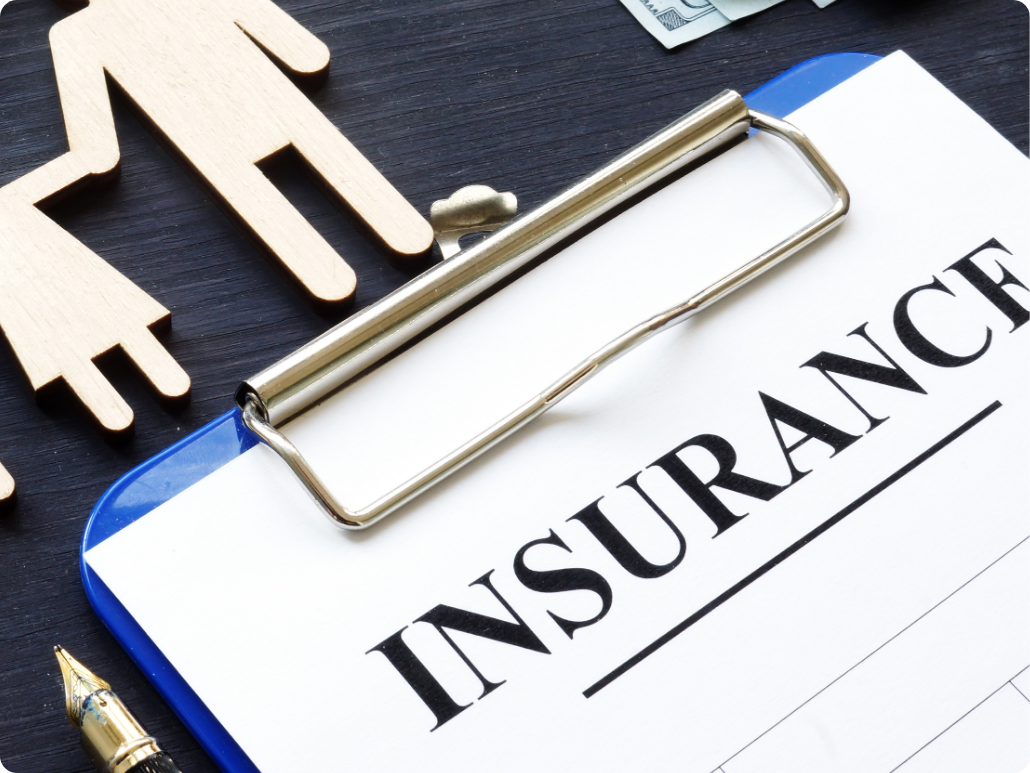 A clipboard with a piece of paper reading 'insurance'.