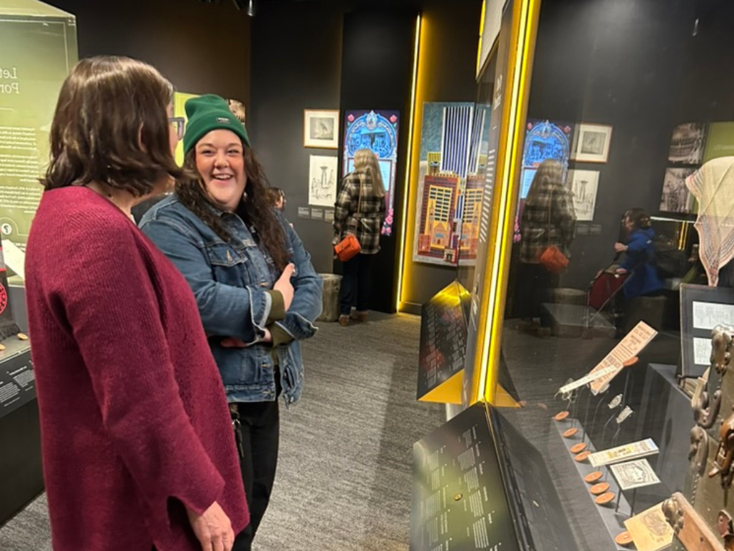 Two members of OCJ's policy team share a laugh while checking out an exhibit at the Oregon Historical Society.