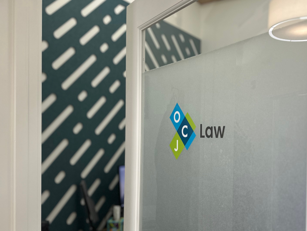 OCJ Law's logo on a glass office door.