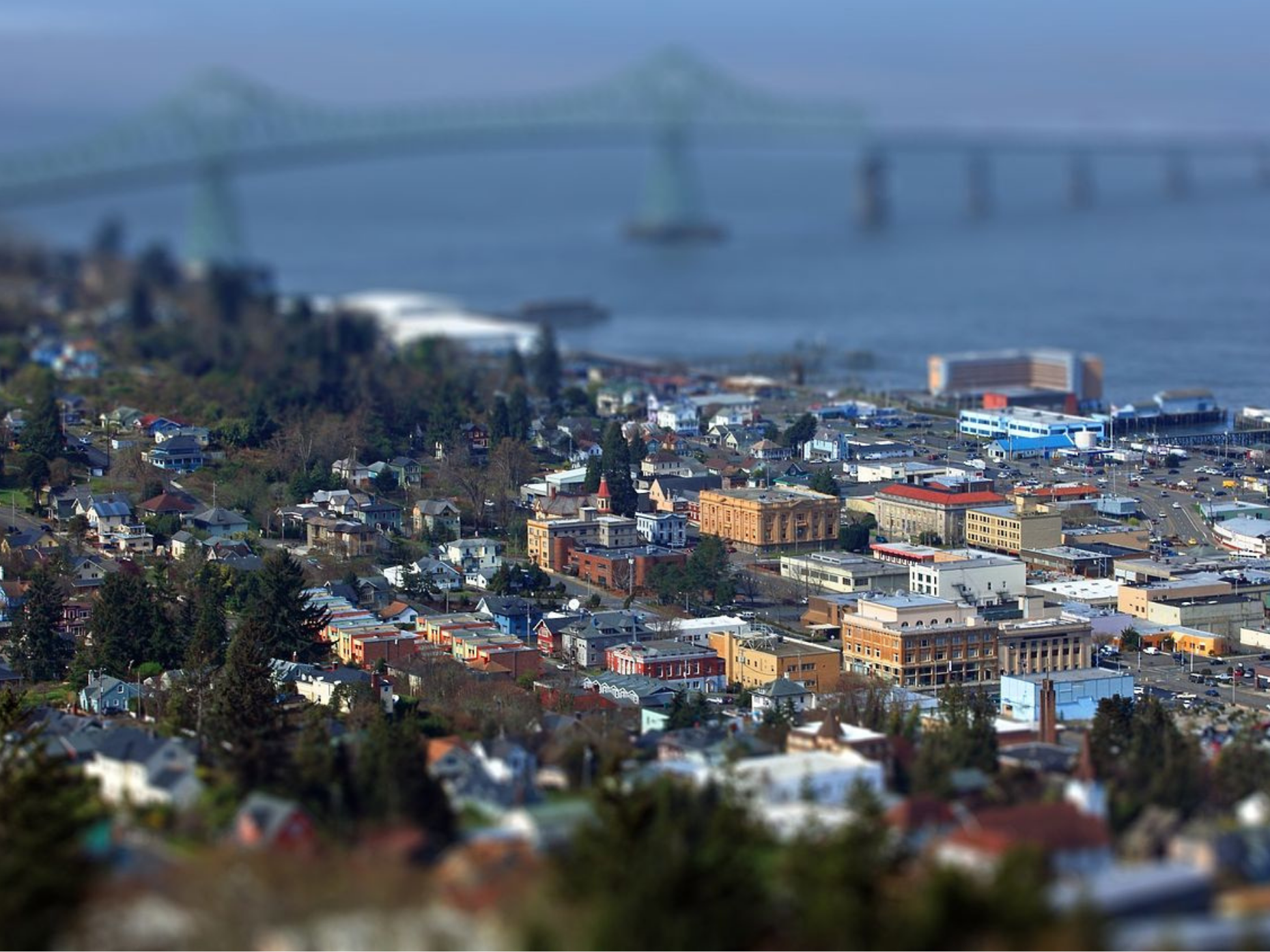 Aerial view of Astoria, Oregon with the Astoria-Megler Bridge in the background.