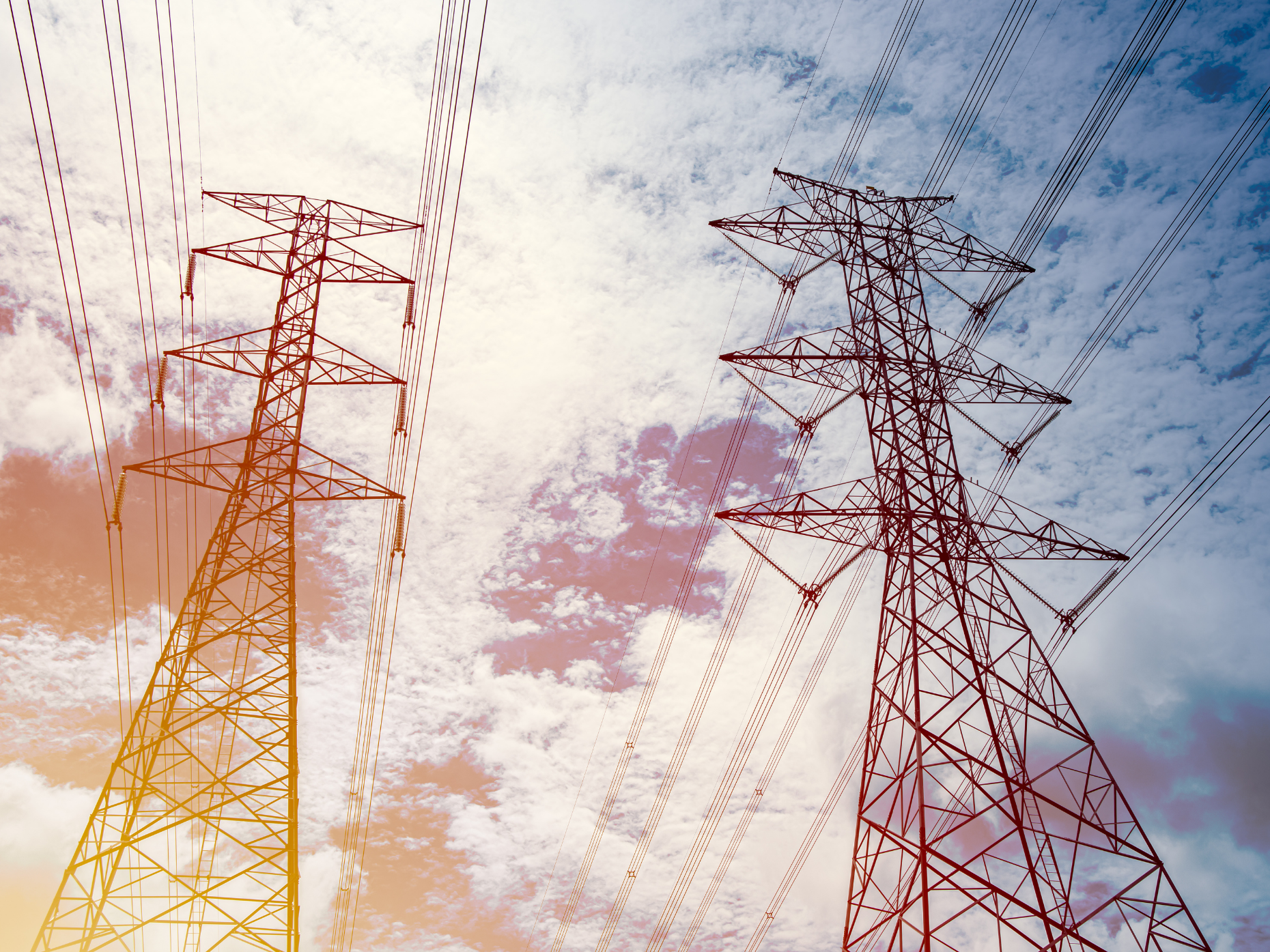 Electrical transmission towers with a blue sky background.