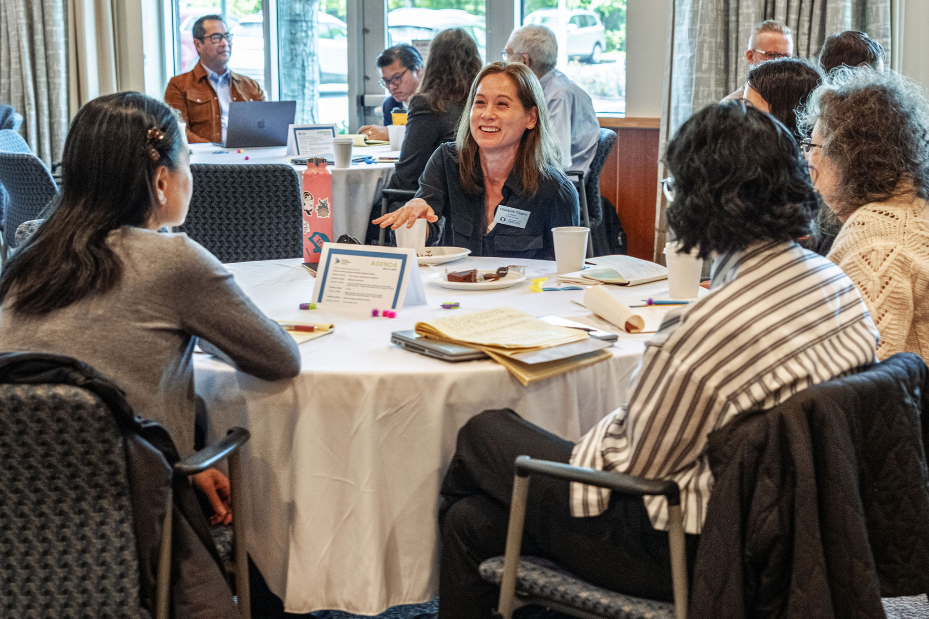 A group of four event participants in discussion at a table.