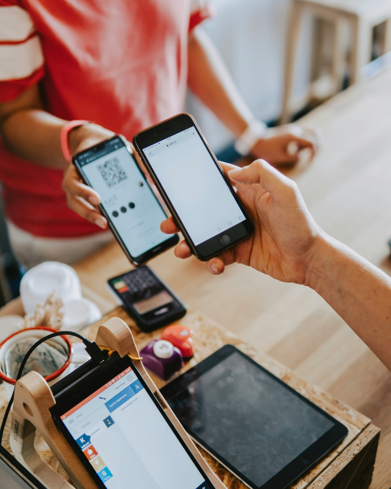 A picture of two people holding their cell phones next to each other for payment.
