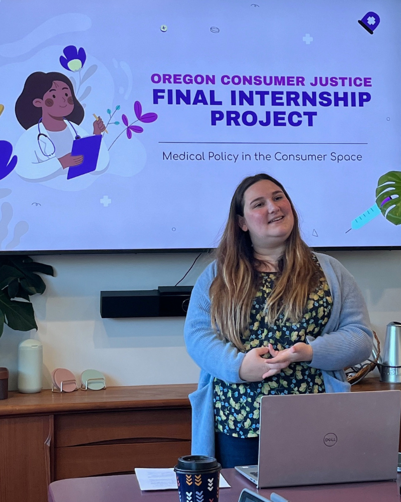 A person presenting in front of a large screen.